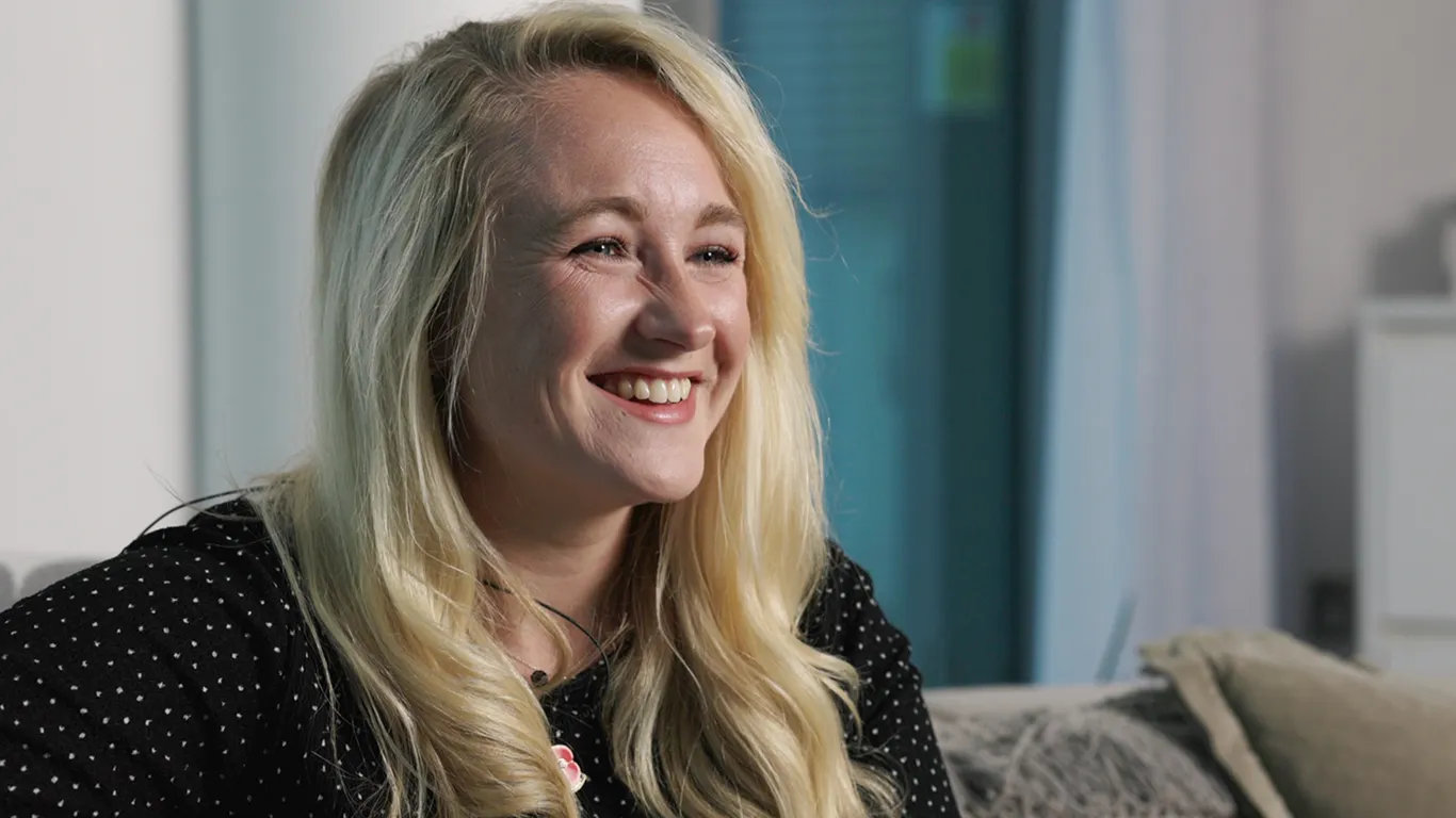 Smiling Strata team member discussing the wellbeing programme that reduced work-related stress by 68%